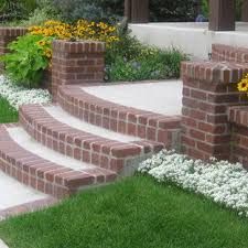 the steps are made out of bricks and have flowers growing on them