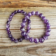 "Very pretty! February birthstone. Genuine, natural purple Amethyst gemstone stretch bracelet. 8mm - LARGE - fits more snug than smaller beads 10mm - LARGE - fits more snug than smaller beads Lengths approximate. 8mm: 7 3/4\" stretching to about 8\" or a little more 10mm: 8\" stretching to about 8 1/4\" or a little more 🌟 7 3/4\" & 8\" generally considered \"One Size Fits Most\" CAN customize length - send me a message 🖤 NO TWO ALIKE 🖤 Some are dark purple, some a light, some mixed dark a Purple Stretch Bracelet With Natural Stones, Purple Natural Stones Stretch Bracelet, Purple Amethyst Stretch Bracelet With Round Beads, Purple Amethyst Stretch Bracelet With Natural Stones, Purple Amethyst Bracelets With 8mm Beads, Purple Amethyst Stretch Bracelet, Purple Amethyst Round Stretch Bracelet, Lavender Amethyst Round Bracelet, Purple Amethyst Bracelet