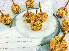 several appetizers are arranged on a plate with toothpicks stuck in them