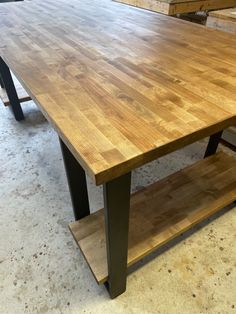 a large wooden table sitting inside of a room