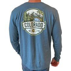 A longsleeve version of our best selling Woodland t-shirt, this Colorado longsleeve t-shirt is an awesome combination of organic outdoor colors and ColoradoCool's bold design style. Features a sweet outdoor Colorado landscape, big "COLORADO" text, Colorado's established date and a nice subtle topo map in the background. The smaller design on the front is perfect for those who like to put into practice a little bit of that "mullet approach", business in the front and party in the back. Snag this Casual Long Sleeve T-shirt For Outdoor Activities, Outdoor Long Sleeve Cotton T-shirt, Casual Long Sleeve Tops For Outdoor Activities, Long Sleeve T-shirt For Fall Adventure, Outdoor Long Sleeve Cotton Tops, Cotton T-shirt For Outdoor Activities In Fall, Blue Screen Print Tops For Outdoor Activities, Blue Tops With Screen Print For Outdoor Activities, Blue Screen Printed Tops For Outdoor Activities