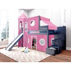 a child's play house with stairs and slide in the middle, next to a rug