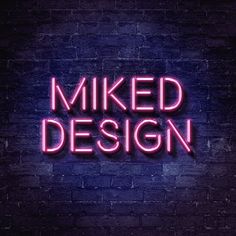 a neon sign that says,'mixed design'on a brick wall in the dark