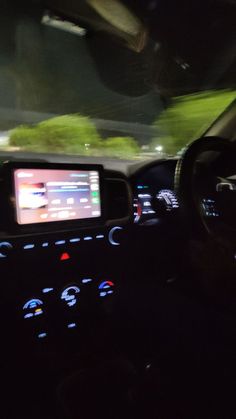 the interior of a car with dashboard lights and electronic display on it's screen