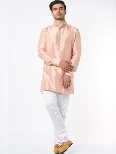 This peach silk kurta will instantly give an elegant look.  Made from blended silk fabric, this peach kurta has an embroidered placket, and a mandarin collar. It is paired with a white churidar pants. An ideal outfit for traditional & special events.

Size Chart For Men





	
	
					Men's Size Chart
		

		
		
						
				Size Chart For Men
				Custom Size Measurement Guide
			
			
				
				
				Custom Size Measurement Guide
1. Take your measurements at ease…don’t hold your breath!
2. Be a little White Churidar, Silk Kurta Set, Silk Kurta, Indian Fashion Designers, Pernia Pop Up Shop, Churidar, Kurta Set, Mandarin Collar, Spring Break