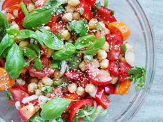 a glass bowl filled with lots of veggies and seasoning on top of it