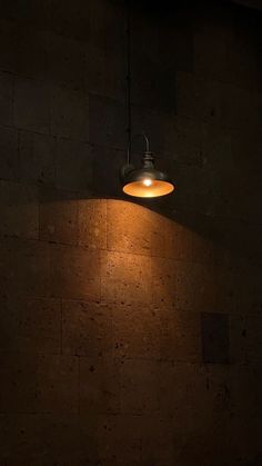 a light that is on the side of a wall in a dark room with no one around it