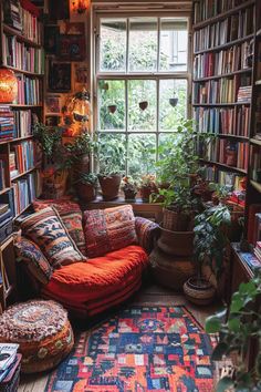 a room filled with lots of books, plants and rugs on the floor in front of a window