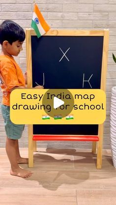 a young boy standing in front of a blackboard with the words easy india map drawing or school written on it