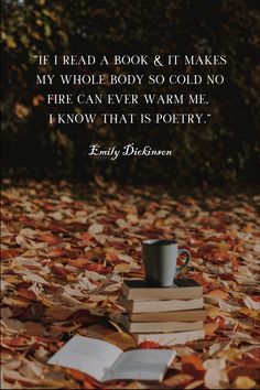 a stack of books sitting on top of leaves next to a coffee cup and book