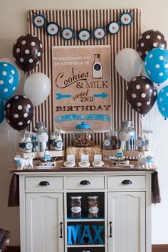 a decorated buffet with blue and white balloons