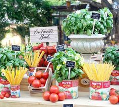 many different types of vegetables on display at an outdoor market table with signs and labels