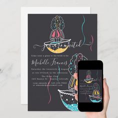 a person holding up a phone next to a card with an image of a boat on it