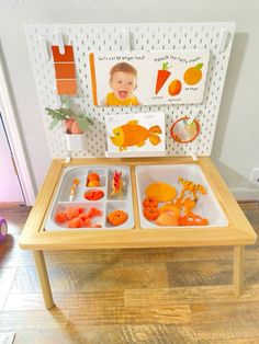 a wooden table topped with trays filled with food