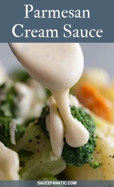 a close up of broccoli and cauliflower being drizzled with cream sauce