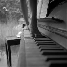 a person standing on top of a piano