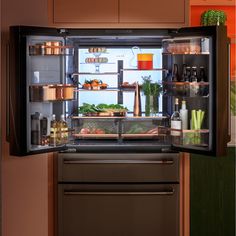 an open refrigerator with food in it and bottles on the door, including carrots