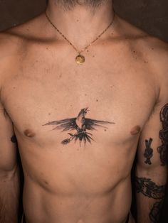 a man with a bird tattoo on his chest