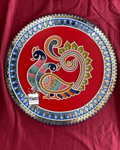 a decorative plate on a red table cloth