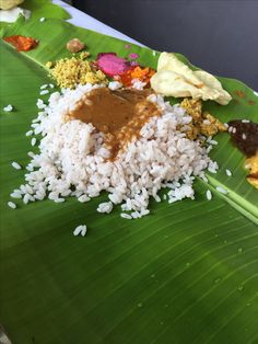 the meal is prepared and ready to be eaten on the banana leaf for lunchtime