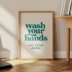 a poster on the wall that says wash your hands you filthy animal with green lettering