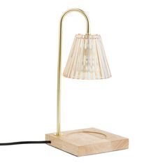 a lamp that is on top of a wooden block with a cord attached to it