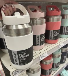 a person is holding a large water bottle in front of some other items on the shelf