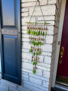 a wall hanging planter on the side of a brick building next to a purple door