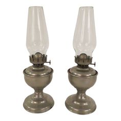 two glass lamps sitting side by side on top of each other