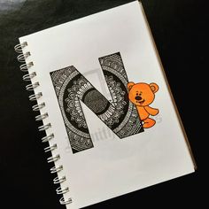 the letter n is made up of doodles and a teddy bear