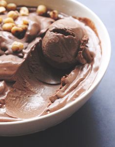 a bowl filled with chocolate and nuts on top of a table