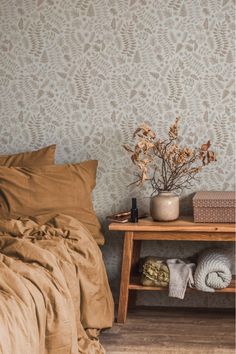 Bedroom with neutral botanical wallpaper, warm-toned bedding, and rustic wooden furniture, creating a cozy and nature-inspired atmosphere. Inviting Bedroom, Rustic Wood Furniture, Leaf Patterns, Indian Prints, Bedroom Retreat, Botanical Wallpaper, Leaf Wallpaper