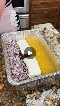 a woman is preparing food in a pan on the kitchen counter