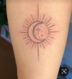 a small sun and moon tattoo on the side of a woman's leg,