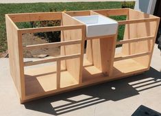 an unfinished kitchen cabinet with a sink in it