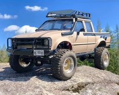 an off - road vehicle is parked on top of a rock in the mountains,