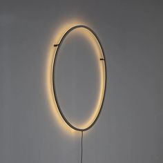 a circular light is lit up on the wall