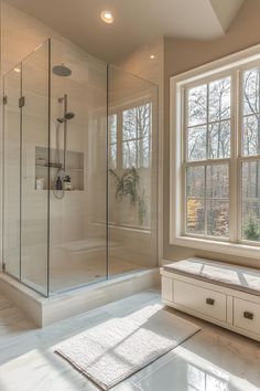 a bathroom with a walk in shower next to a window