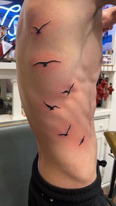 a man's back with birds on it