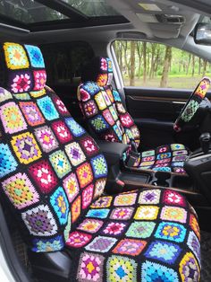 the interior of a car with crocheted blankets on it