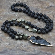 Shop evelyncreations's closet or find the perfect look from millions of stylists. Fast shipping and buyer protection. Obsidian is truth-enhancing. A strongly protective stone, it forms a shield against negativity. It blocks psychic attacks and absorbs negative energies from the environment. Obsidian draws out mental stress and tension. It stimulates growth on all levels, urging exploration of the unknown and opening new horizons. Brings clarity to the mind and clears confusion. Lava Stone is a Yoga Mala Beads, Lava Stone Necklace, Arrow Pendant Necklace, Obsidian Arrowhead, Men Yoga, Black Obsidian Stone, Obsidian Necklace, Yoga Mala, Rock Necklace