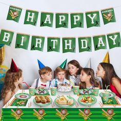 a group of children sitting at a table with birthday hats on and cake in front of them