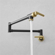 the faucet with two handles is shown in gold and black