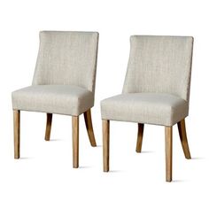 a pair of beige chairs sitting next to each other