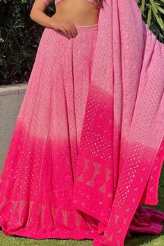 Fuchsia lehenga with chikankari embroidery in floral, paisley motifs and mukaish work. Paired with embroidered blouse and embroidered dupatta.
Component: 3
Pattern: Embroidered
Type Of Work: Chikankari, Mukaish
Neckline: Sweetheart
Sleeve Type: Short Sleeves
Fabric: Georgette
Color: Pink
Other Details: 
Floral motifs
Mukaish work
Occasion: Wedding - Aza Fashions Designer Pink Lehenga With Motifs, Festive Pink Sharara With Motifs, Pink Unstitched Sharara With Motifs, Unstitched Pink Sharara With Motifs, Pink Anarkali Set With Motifs For Diwali, Pink Sharara With Motifs For Navratri, Pink Motif Sharara For Reception, Pink Lehenga With Motifs For Navratri, Pink Navratri Sharara With Motifs