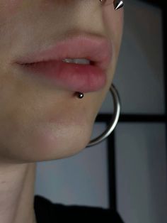 a woman with piercings on her nose