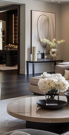 a living room filled with lots of furniture and flowers on top of a coffee table