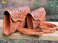 a brown leather purse sitting on top of a wooden bench