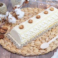 a piece of cake sitting on top of a basket next to some cotton and twine