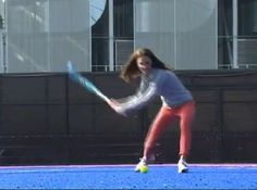 a woman is playing tennis on the court